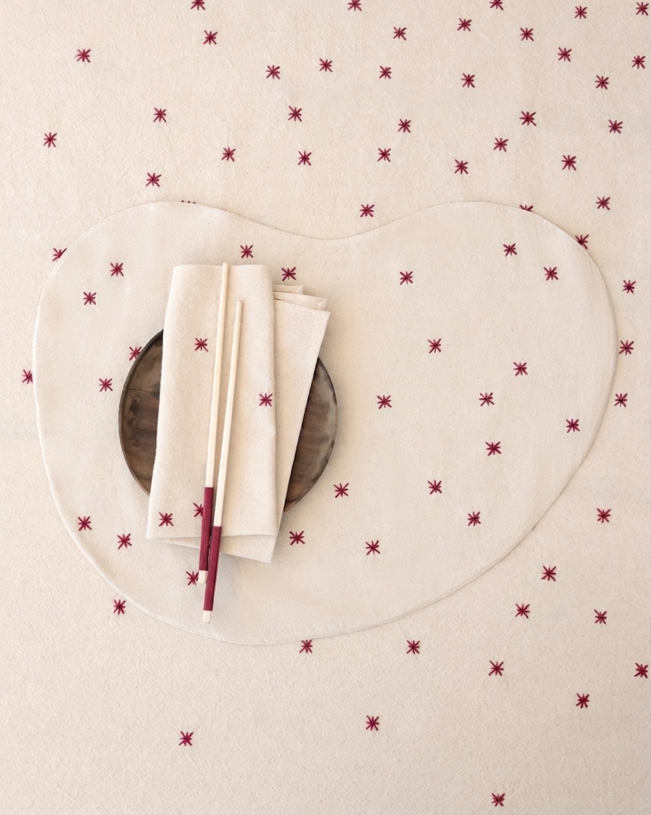 VALERIE BARKOWSKI NOON ECRU NAPKIN WITH CARMINE TRIM CREDIT TANIA PANOVA
